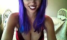 חברה עם שיער סגול מציגה את החזה הסקסי שלה