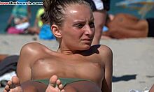 Iubita amatoare bronzată își arată sânii pe o plajă de nudiști în HD